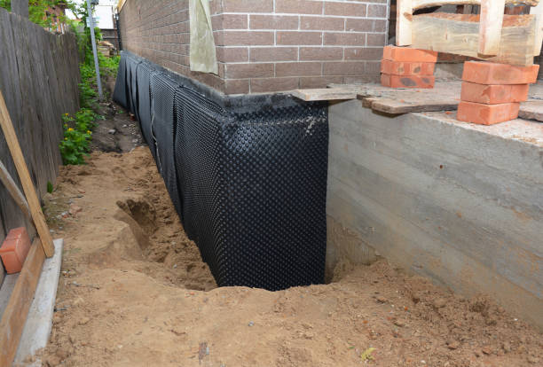 SJ Waterproofing Pros technician performing targeted Wet Basement Repair assessment in Somerset, KY